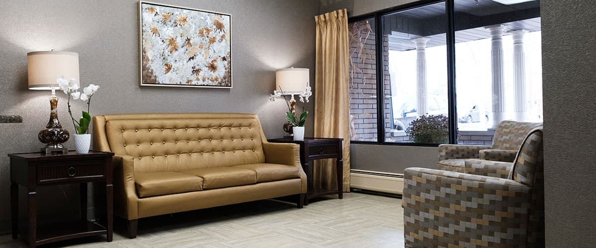 Upscale lobby lounge with tufted leather sofa and elegant lighting at Embassy Oaks
