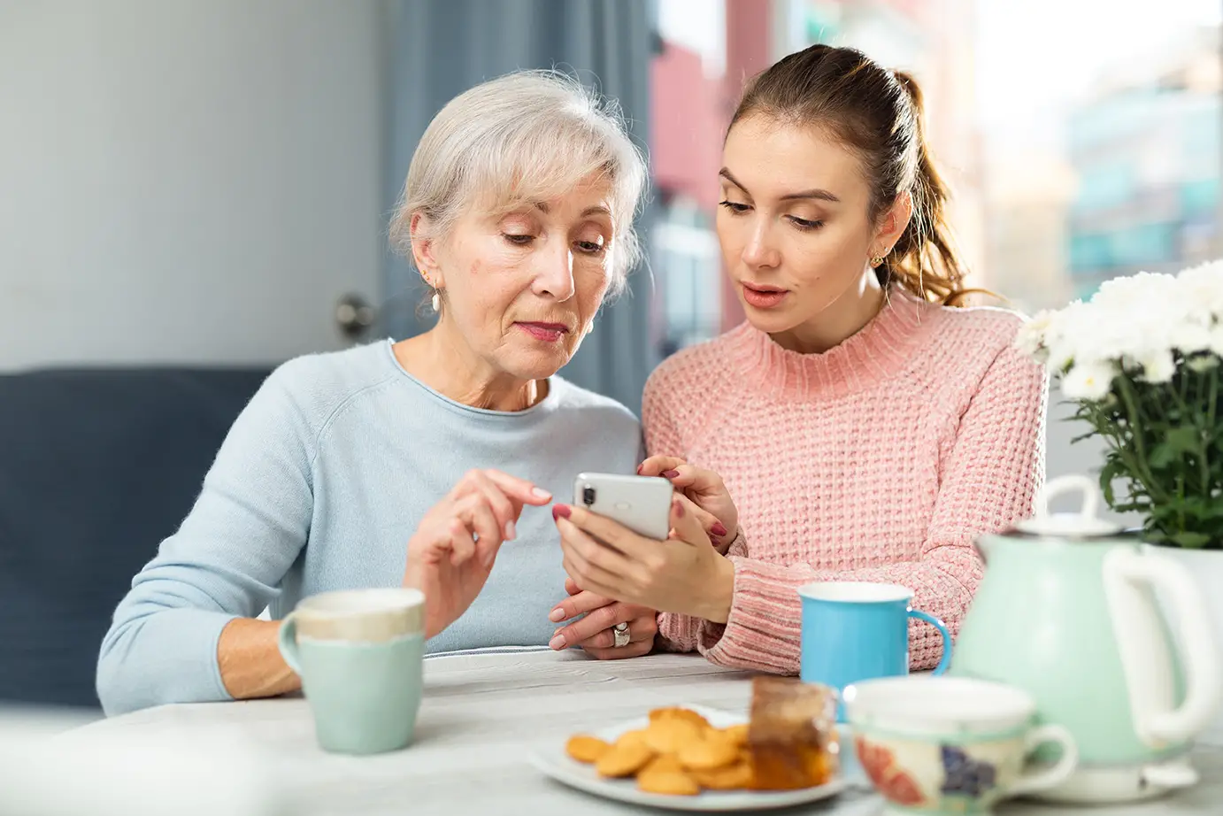 Person making a phone call while reviewing documents during the admission process