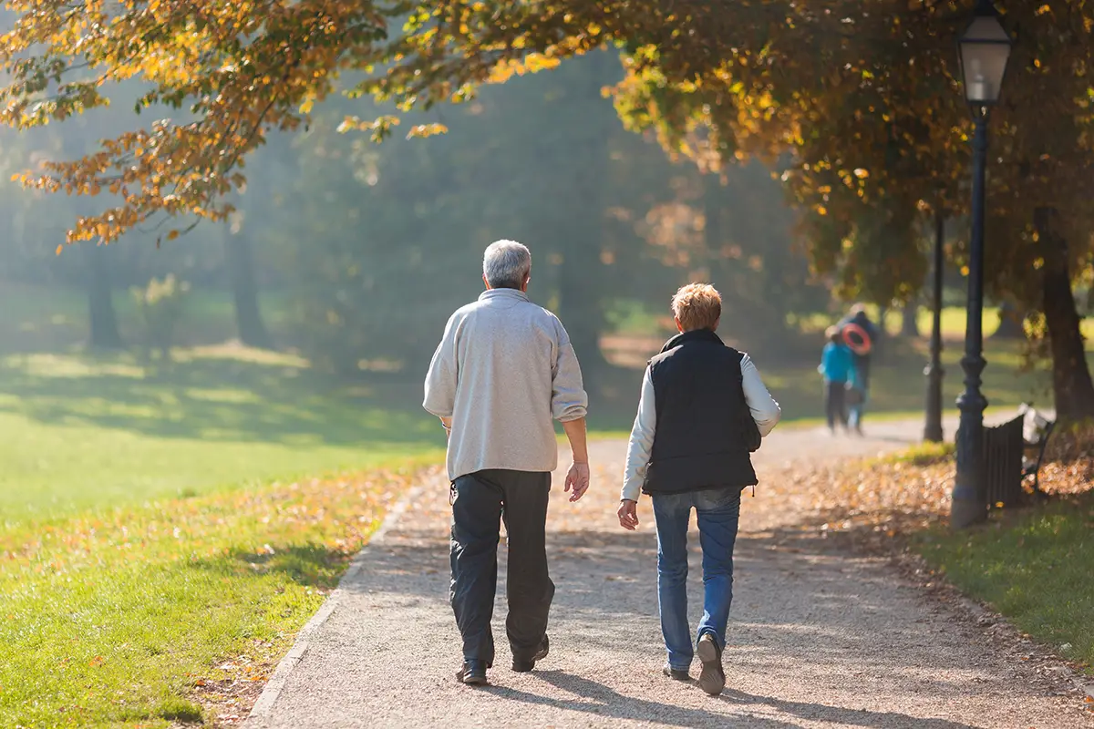 Elderly couple walking outdoors during the admission process for non-hospitalized residents
