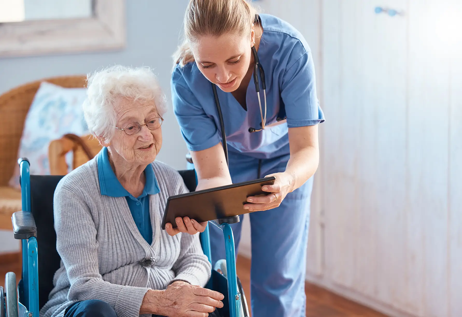 Nurse helping an elderly patient understand financing options during admission