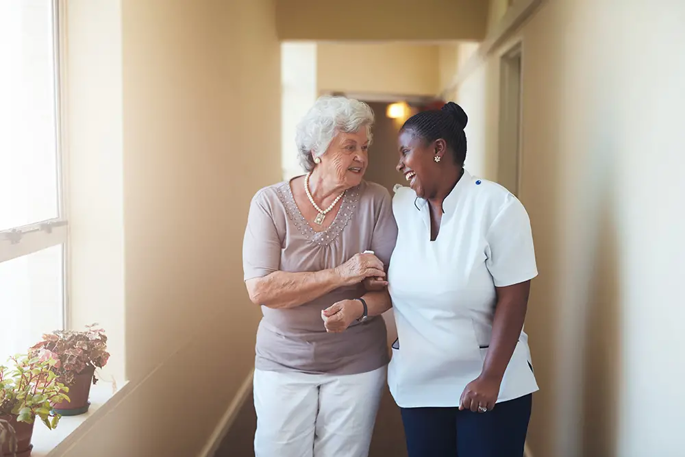 Elderly woman meeting with admissions staff at an Embassy Healthcare facility