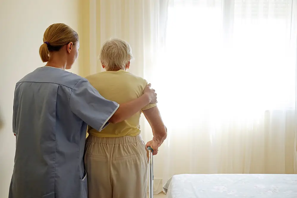 Elderly woman and caregiver reviewing admission documents together