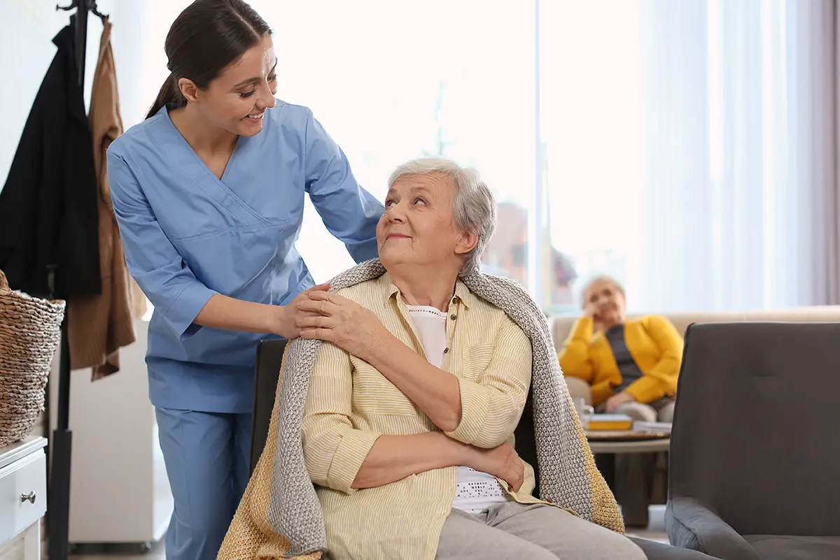 Caregiver providing personalized one-on-one care to a senior at adult daycare