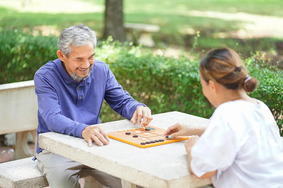 Senior man enjoying social activities and companionship at adult daycare