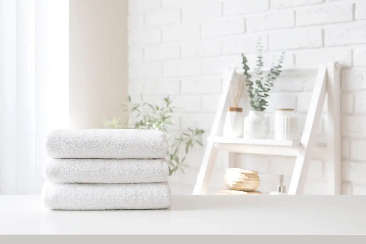 Clean folded towels representing housekeeping and laundry services in assisted living