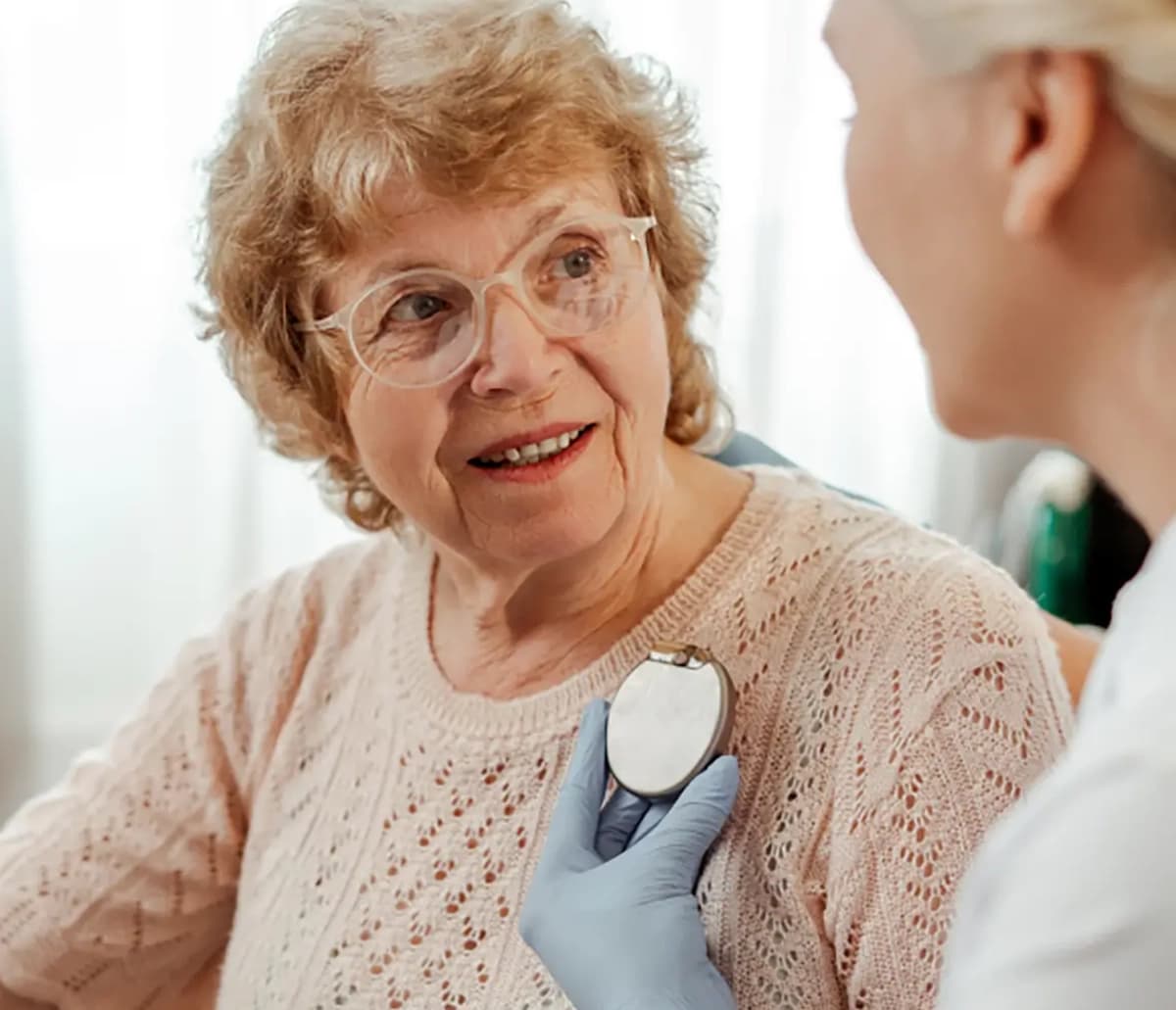 Smiling elderly woman during a cardiac care assessment at Embassy Healthcare