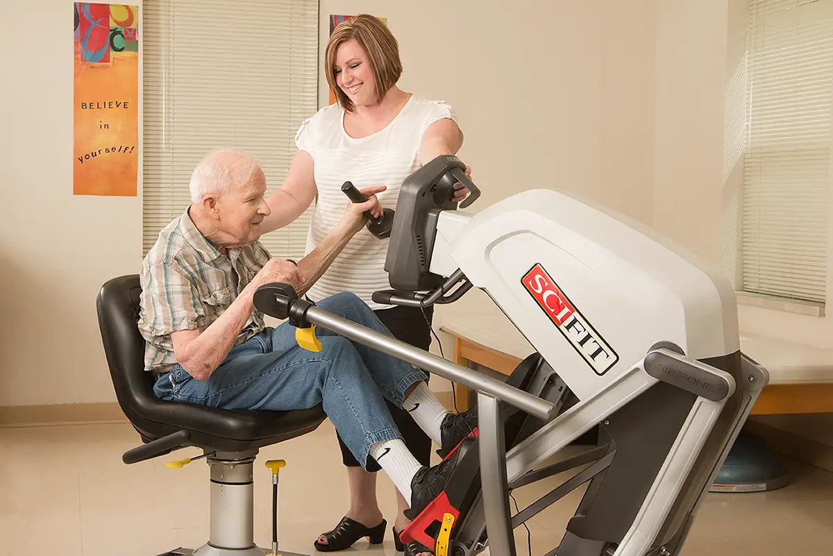 Elderly man exercising on a stationary bike as part of a diabetes care exercise program