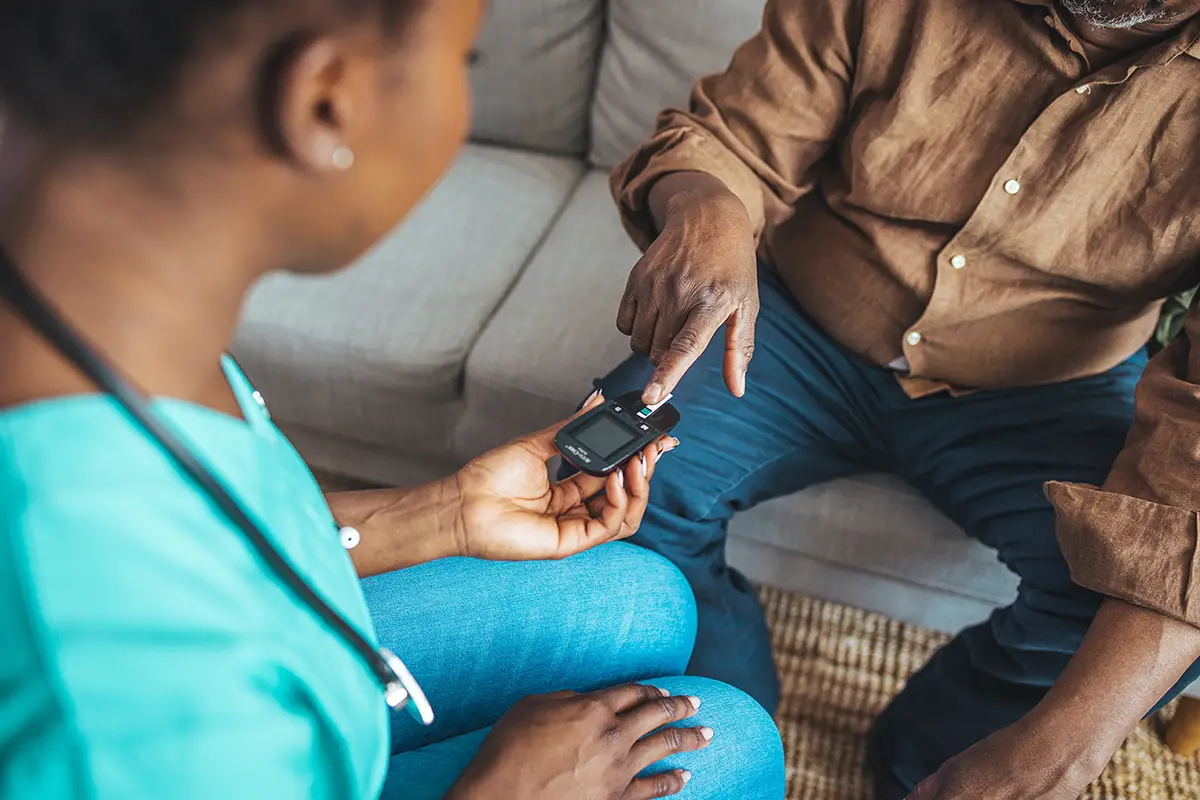 Elderly woman checking her blood sugar as part of diabetes care management