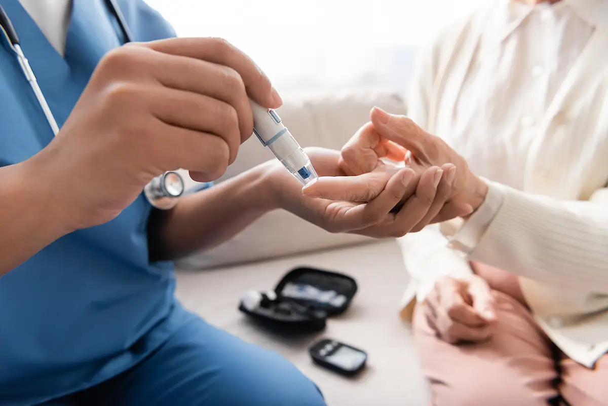 Nurse checking blood pressure of a diabetes care patient