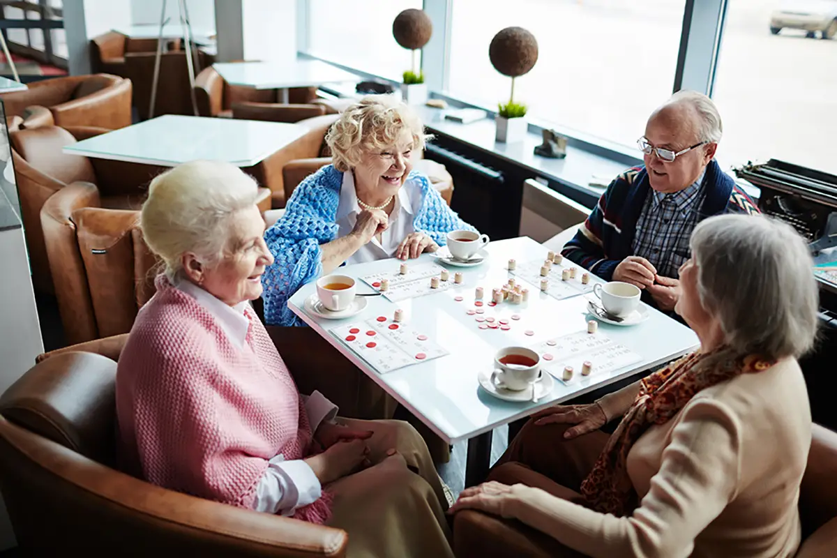 Seniors and caregivers enjoying activities together at an adult daycare facility