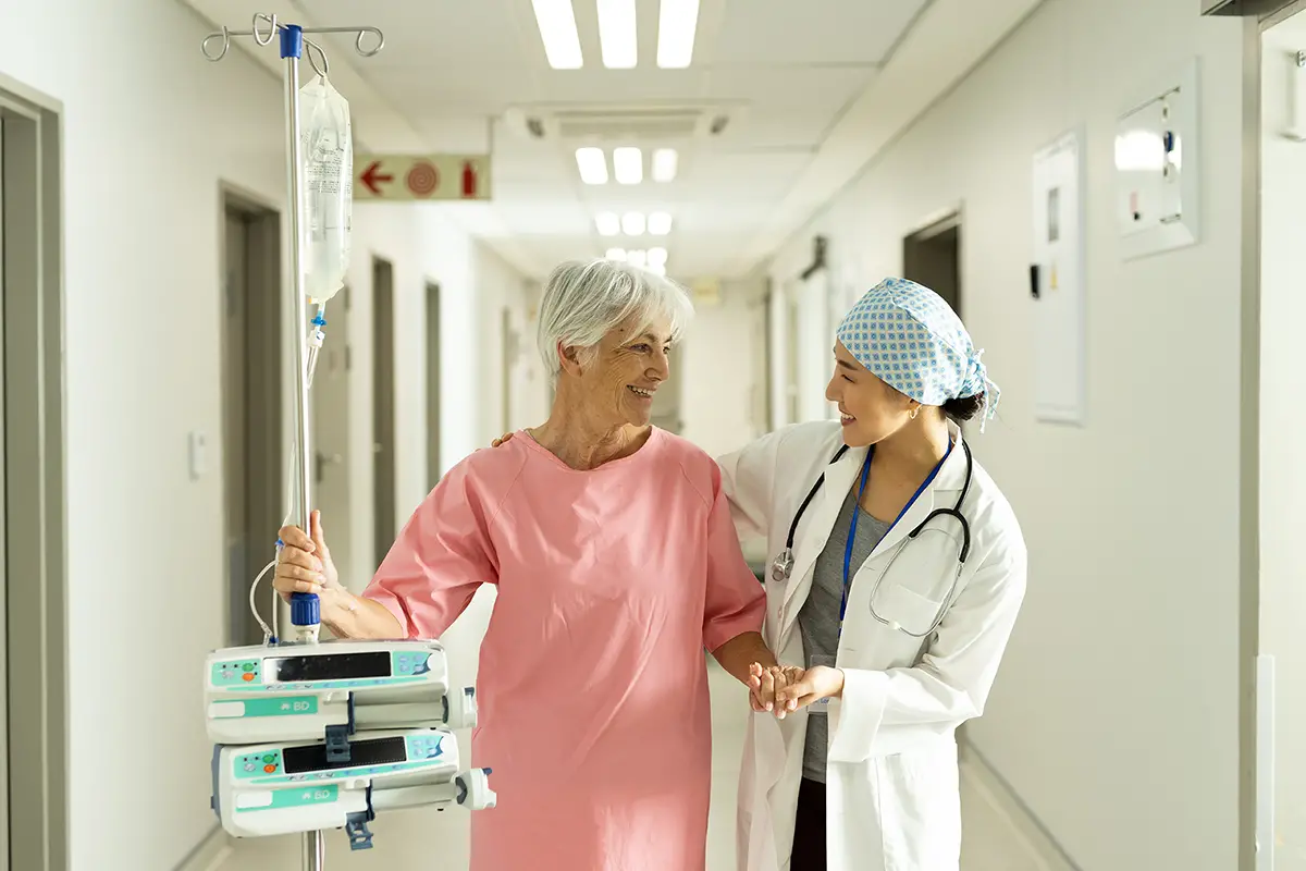 Nurse administering antibiotic and antiviral IV therapy to a patient