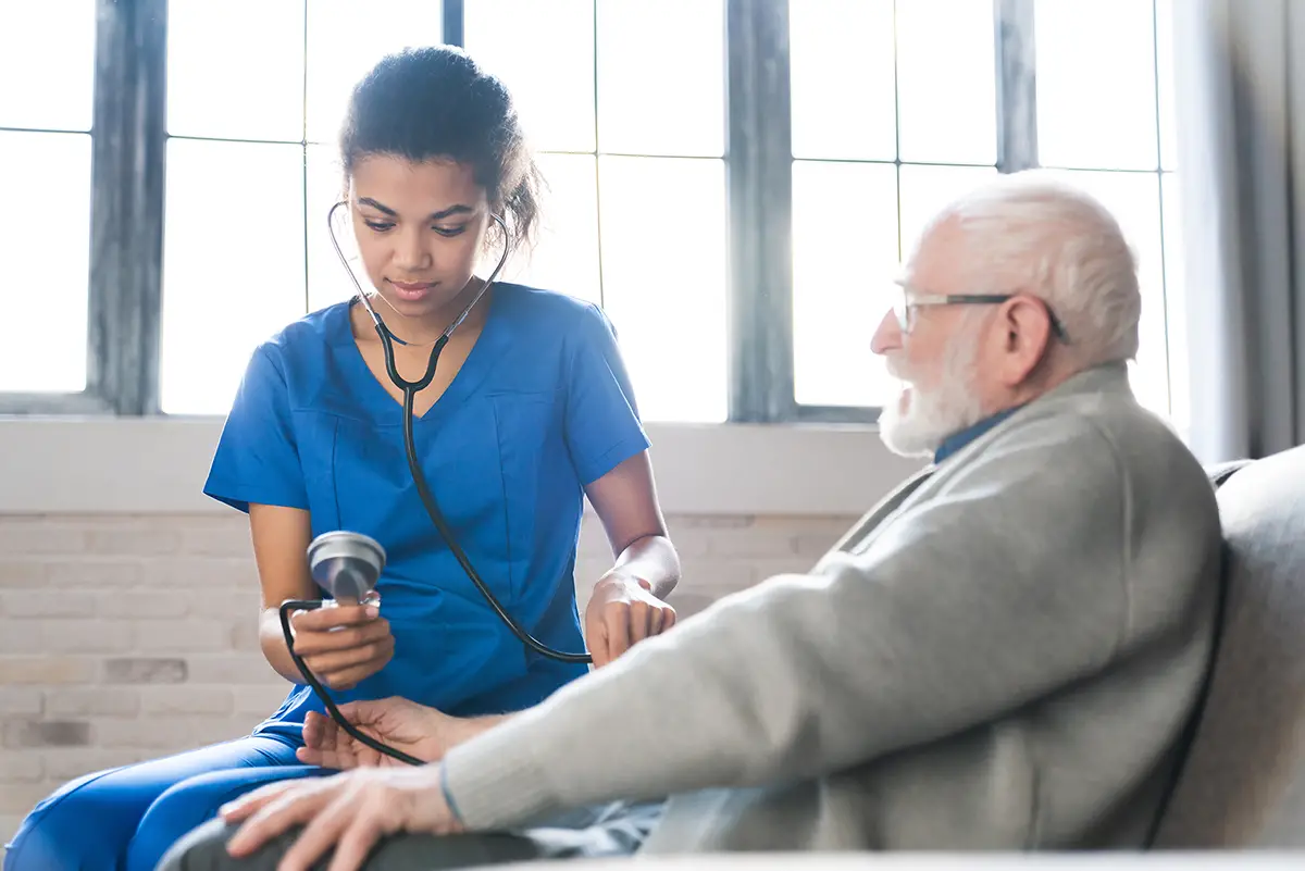 Nurse providing comprehensive nursing care to an elderly patient in a long-term care setting