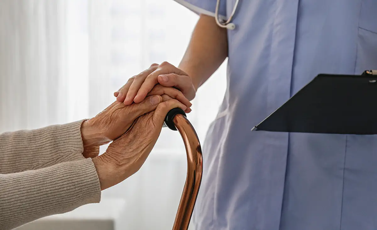 Senior man using a tablet device, demonstrating enhanced quality of life in long-term care