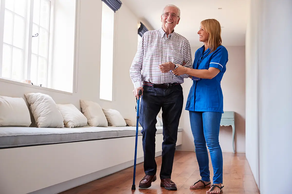 Caregiver assisting a long-term care resident with activities of daily living