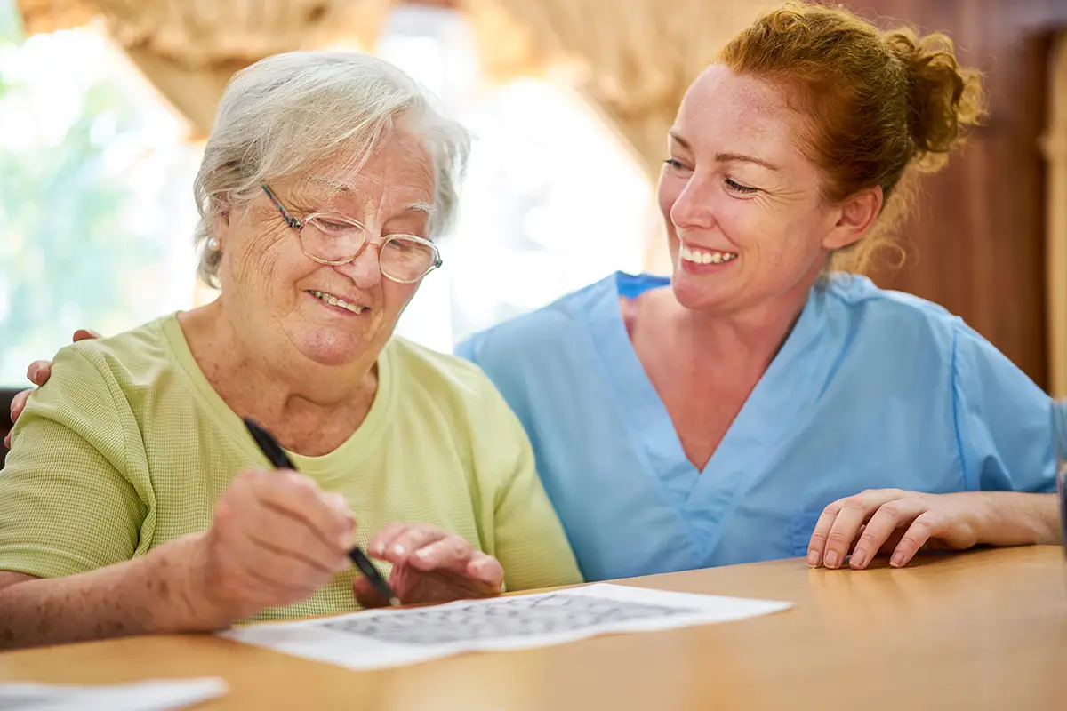 Smiling elderly women enjoying companionship in a memory care community