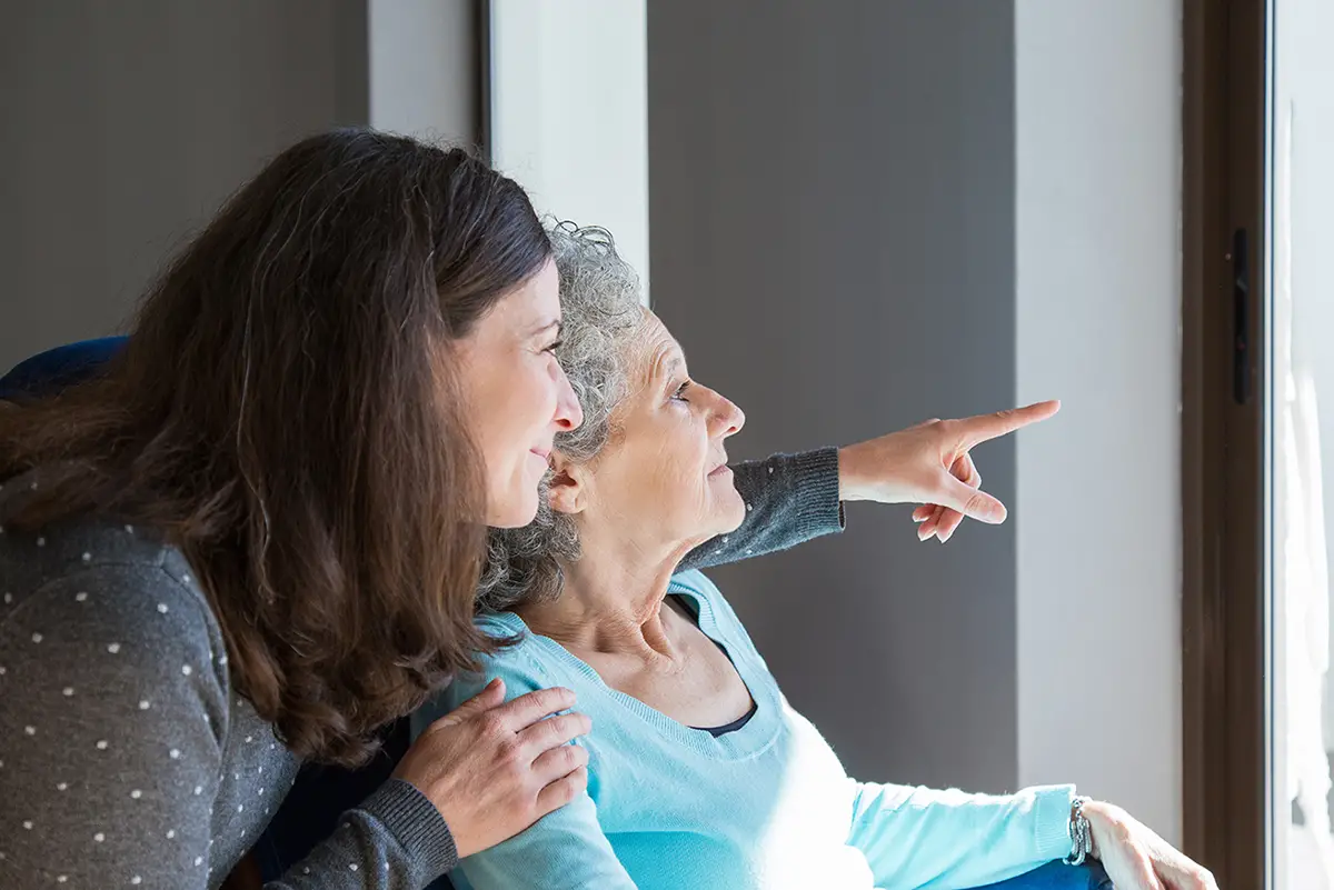Caregiver engaging with a memory care resident to improve daily living
