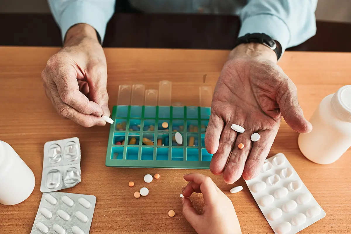 Close-up of medication management with a pill organizer for memory care residents