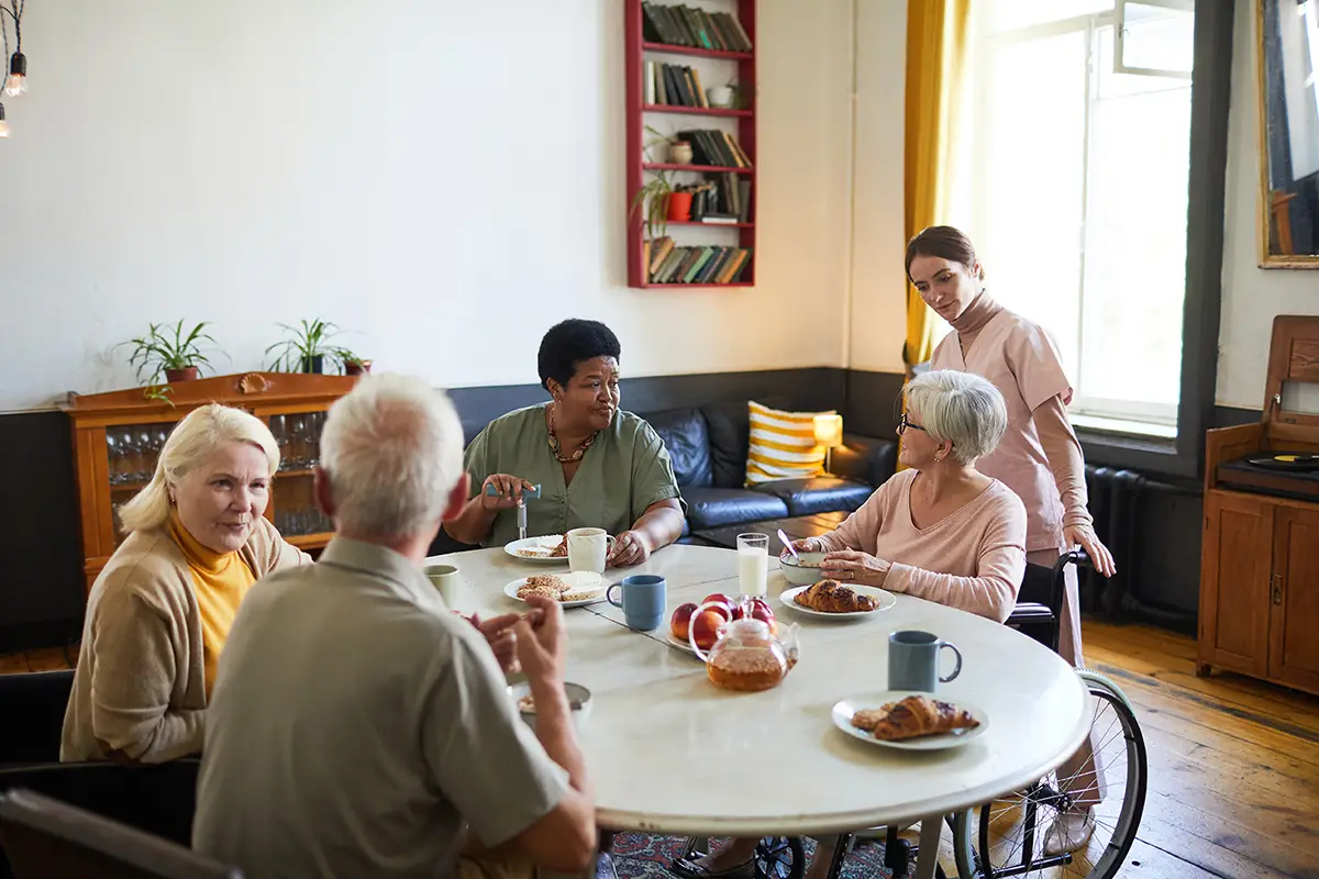 Elderly residents enjoying meals together in a nutrition care dining setting