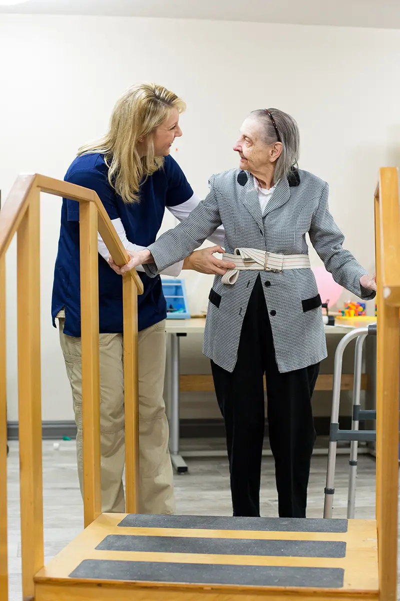 Healthcare worker assisting a patient with orthopedic care rehabilitation