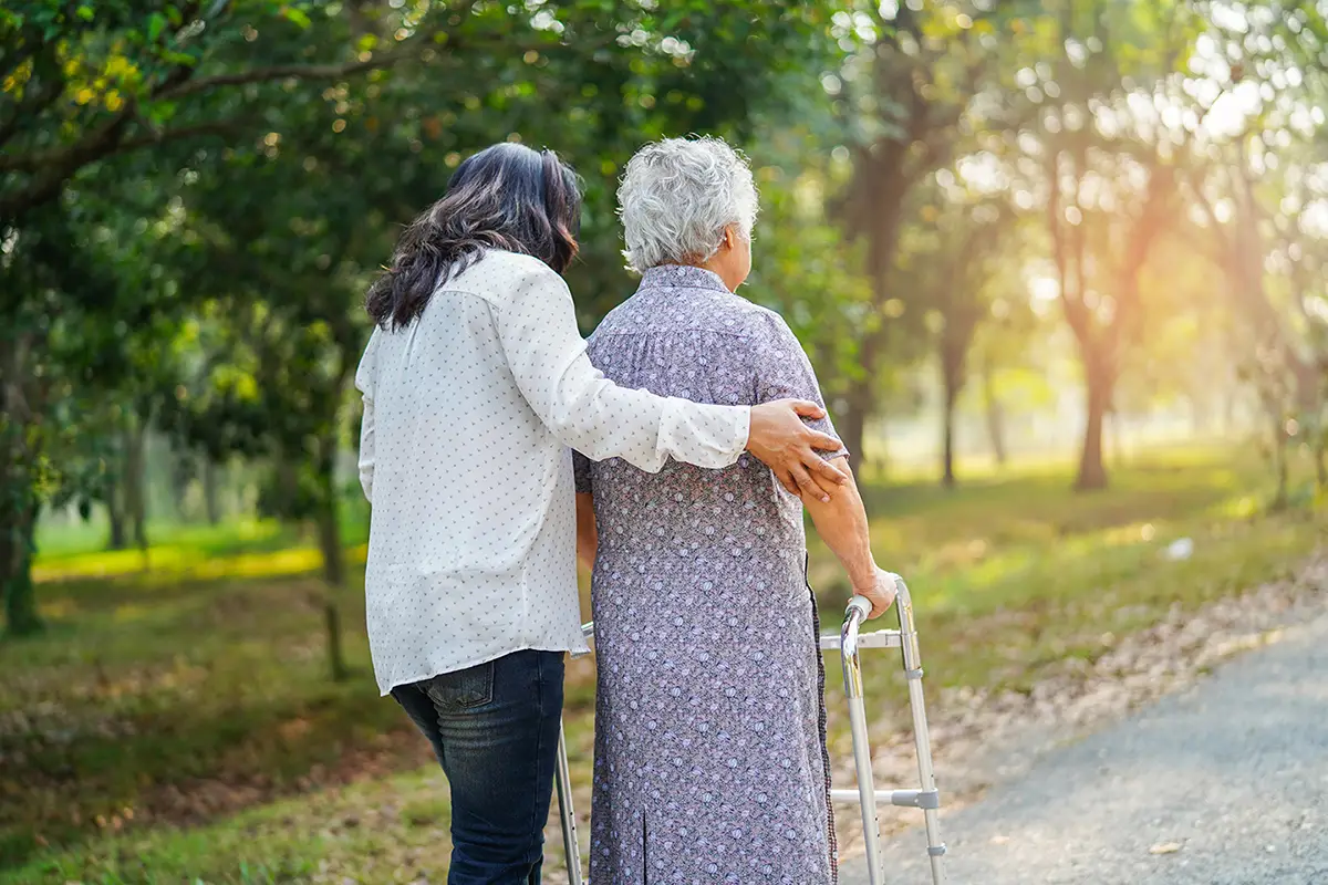 Nurse assisting a patient with post-surgical orthopedic care and recovery