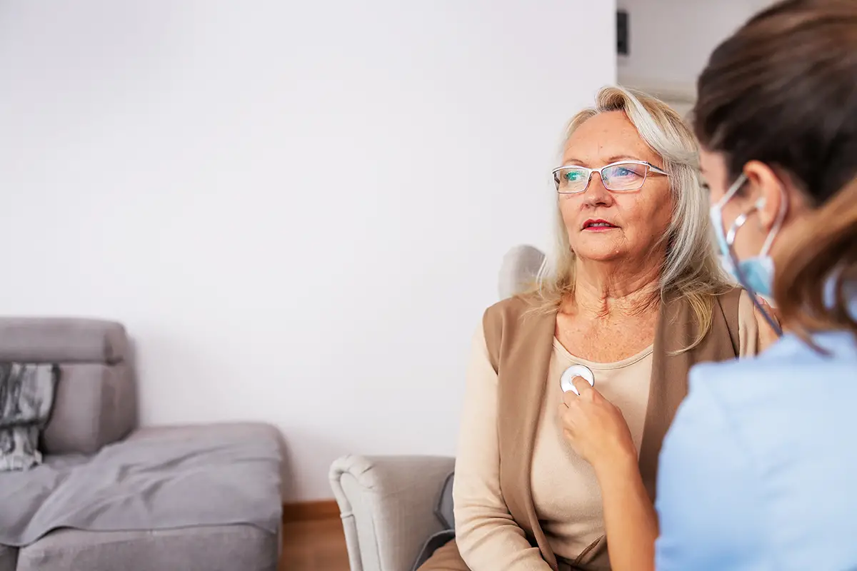 Elderly woman receiving compassionate pulmonary care from a healthcare provider