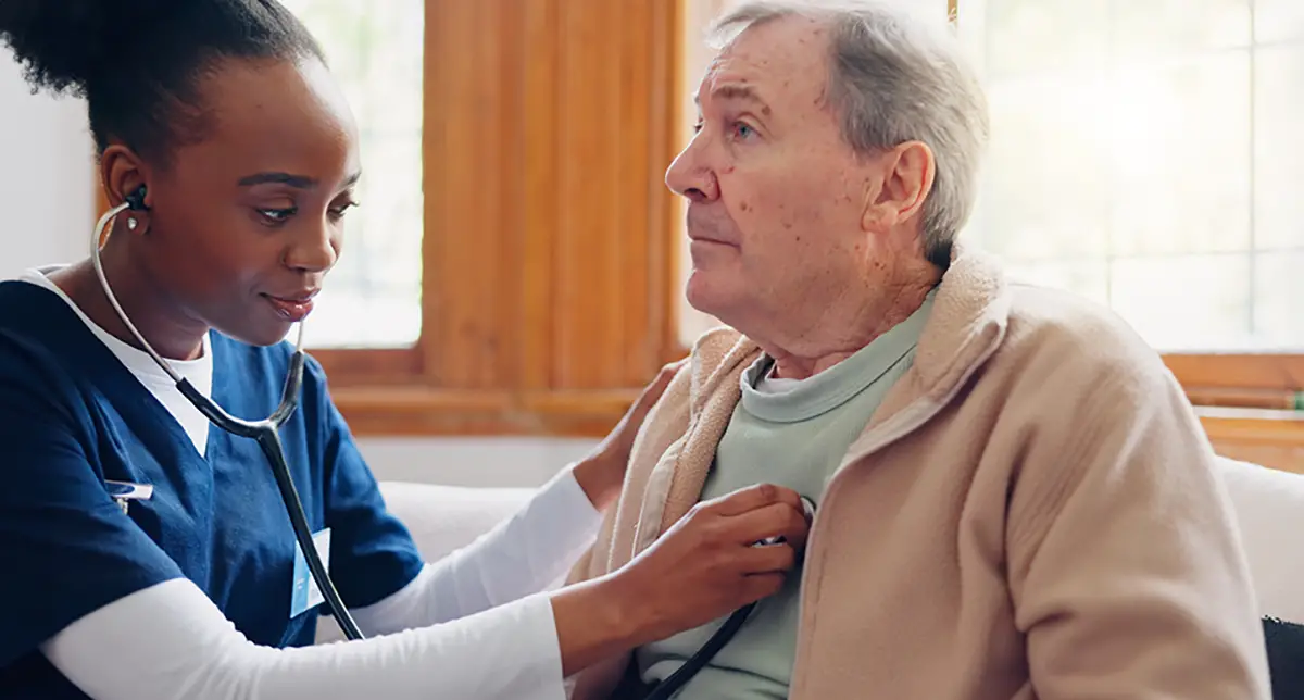 Elderly man receiving pulmonary care assistance from a healthcare professional