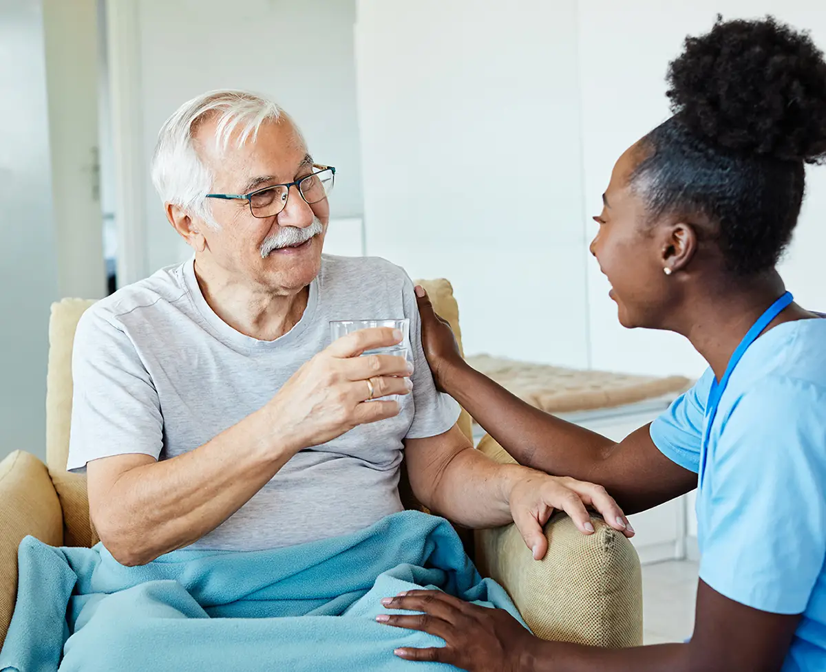 Elderly man receiving pulmonary medication management from a healthcare provider