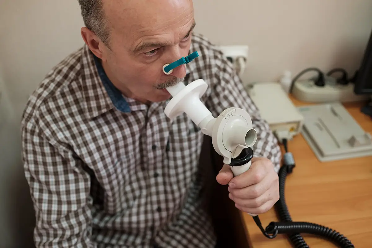 Healthcare provider administering oxygen therapy to an elderly patient