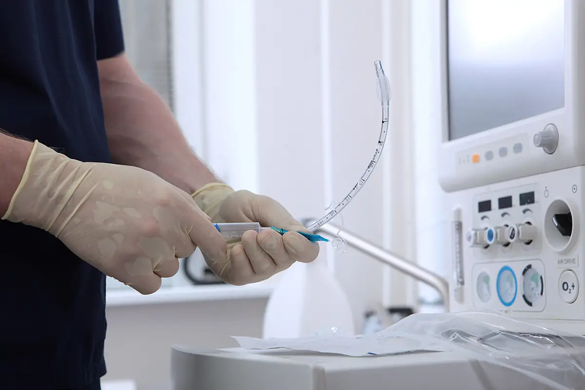 Medical professional providing tracheostomy care in a pulmonary care setting