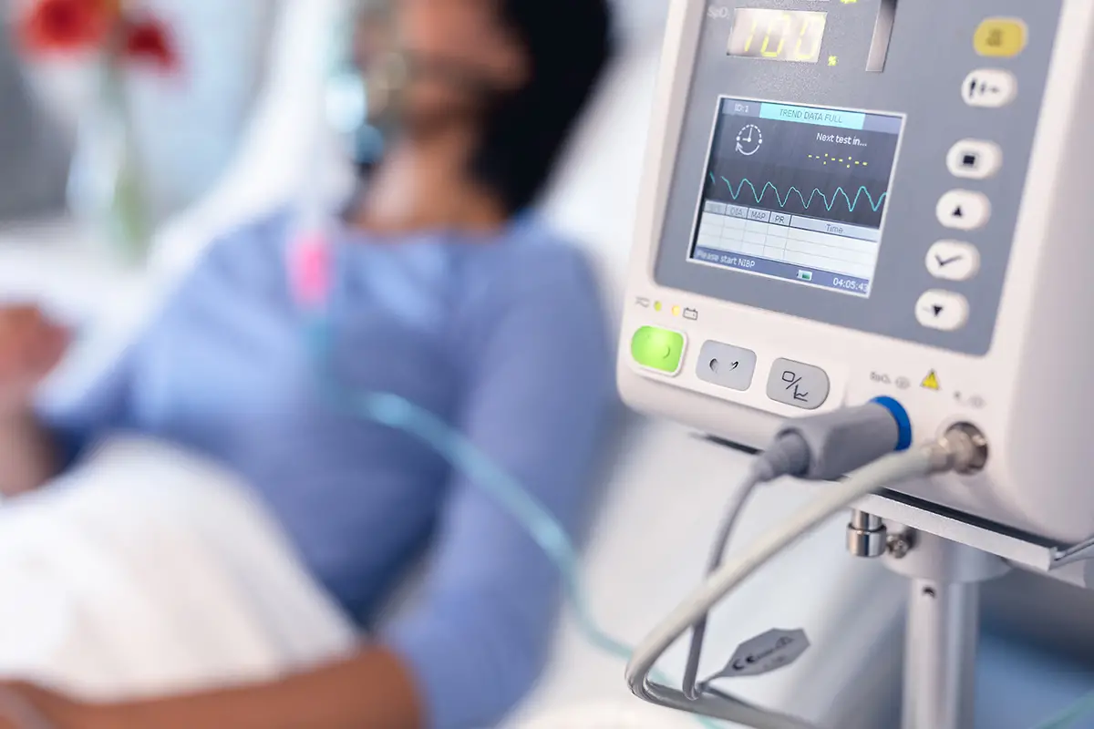 Medical professional managing ventilator equipment for pulmonary care patients