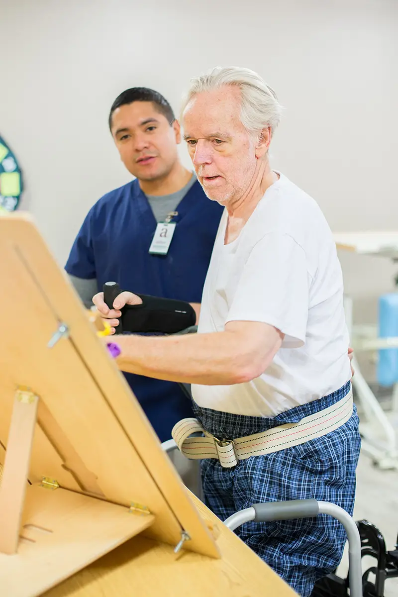 Physical therapist guiding a patient through rehabilitation exercises