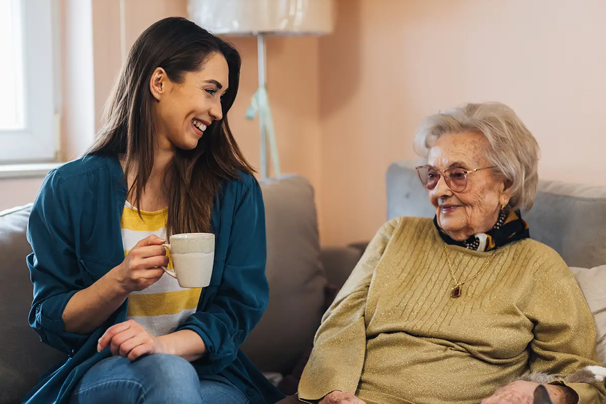 Caregiver providing attentive respite care to an elderly woman