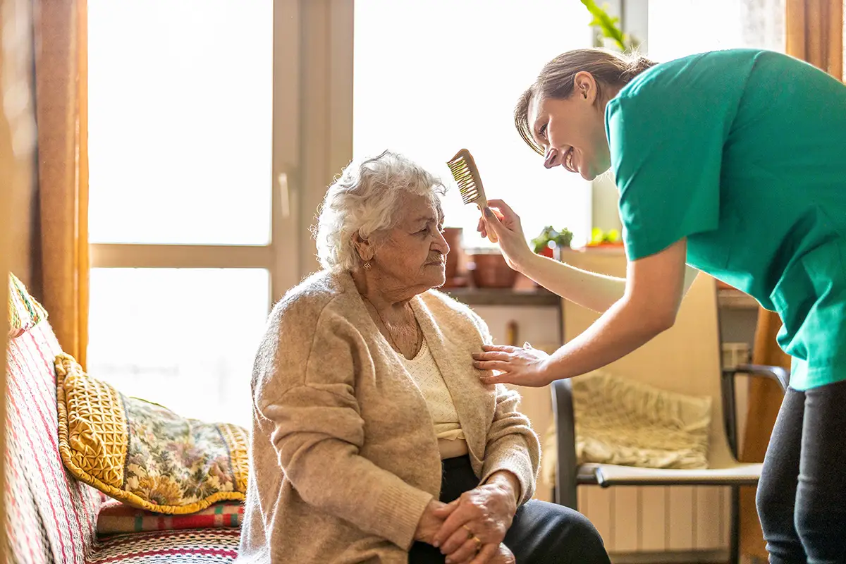 Caregiver providing personal care assistance to a respite care resident