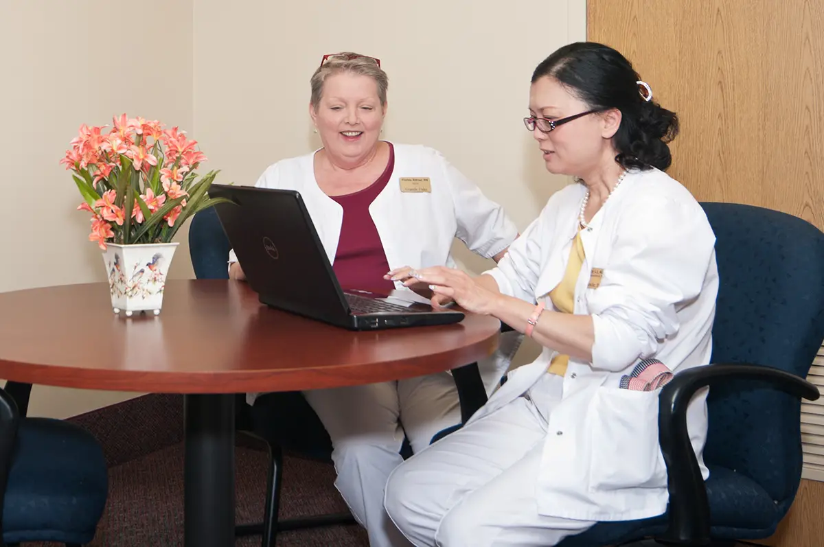 Nurse providing attentive skilled nursing care to an elderly woman