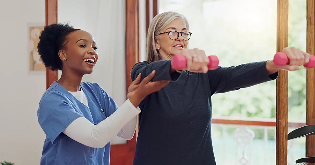 Staff member leading comprehensive rehabilitative exercises with a skilled nursing patient