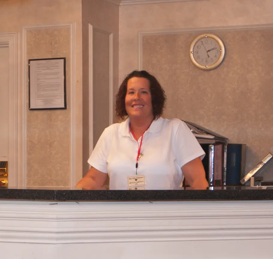 Smiling Embassy Healthcare staff member greeting visitors