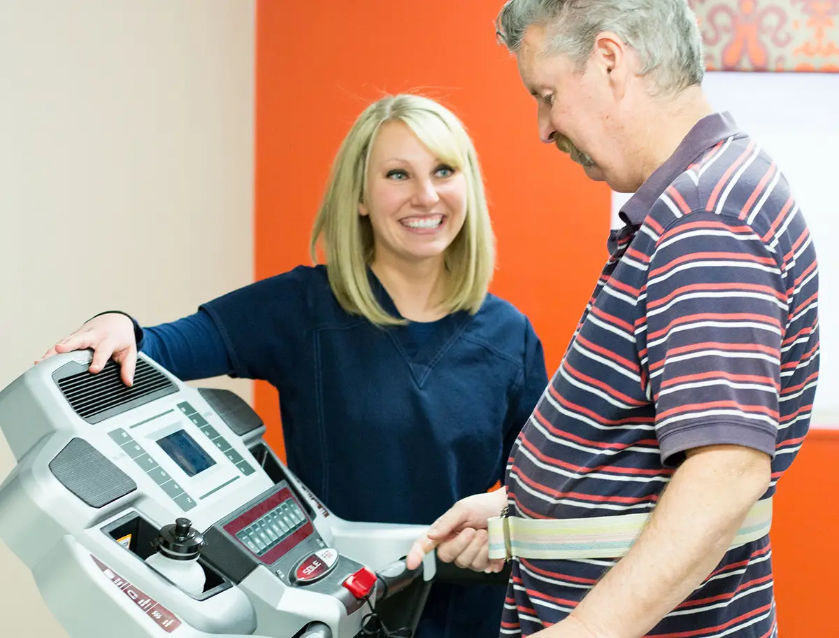 Young woman and elderly resident sharing a joyful moment at Embassy Healthcare